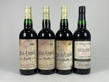 three bottles of wine sitting on top of a white table