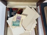 a box with a lot of stamps in it on a table