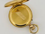 an image of a gold pocket watch on a white surface