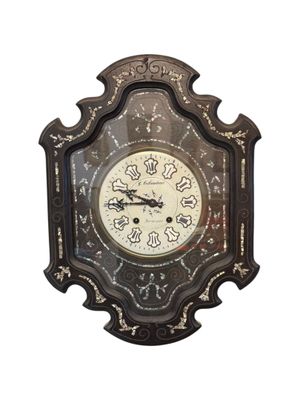 a clock that is hanging on the wall on a white background