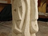 a sculpture of a man and a woman on a wooden table