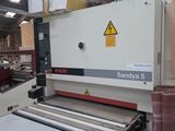 a machine that is cutting a sheet of paper in a factory