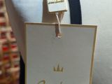 a label on a mannequin with a crown on it