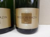 two bottles of champagne sitting on a counter top next to each other