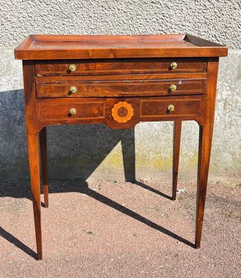 a small wooden table with a drawer on top of it