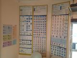 posters on the wall of a room with chairs and a table