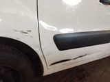 a white car that has been damaged and is sitting in a garage
