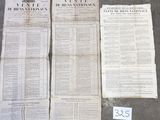 trois journaux sont posés par terre à côté d'une feuille de papier