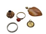 three rings, a ring holder, a ring and a ring on a white surface