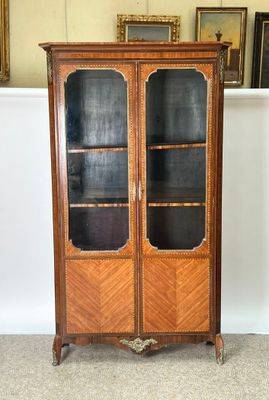 an image of a wooden cabinet with glass doors in a room