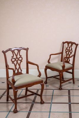 two chairs sitting next to each other on a tiled floor