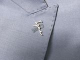 a close up of a person ' s shirt with a pin on it