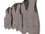 three men ' s vests hanging on a wall in a row