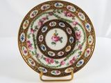 a close up of a plate on a stand on a white background