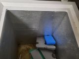 a small refrigerator with a blue light in it