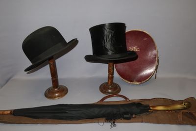 three hats and an umbrella sitting on a table