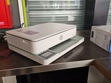 a white printer sitting on top of a counter