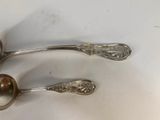 two spoons that are sitting on a table
