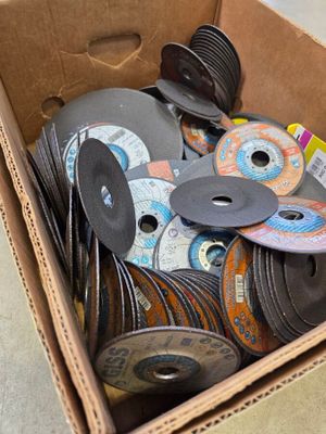 a cardboard box filled with various types of discs