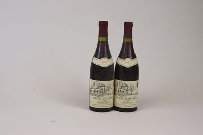 two bottles of wine sitting next to each other on a white surface