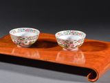 pair of chinese porcelain bowls on a wooden tray on a gray background
