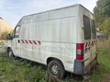 a white van that is parked in the grass