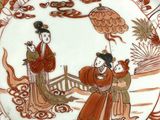 a plate with a picture of a woman and a man on it