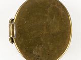 a close up of a gold pocket watch with a white background
