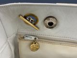 a close up of a purse with a key in it