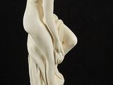an image of a statue of a woman sitting on top of a pedestal