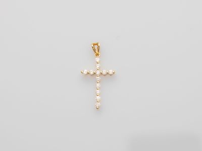 a diamond cross pendant on a white background