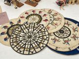 four coasters with different designs on them on a table
