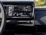 a dashboard of a car with a radio and a steering wheel