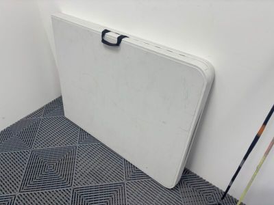 a white table with a black handle in a room