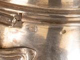 a close up of a silver pot on a table