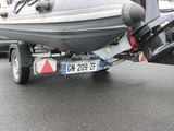 a boat on a trailer parked in a parking lot