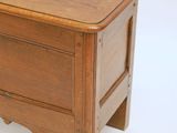 a small wooden chest sitting on a white surface
