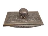 an old silver box with a metal lid and a lid with a design on it