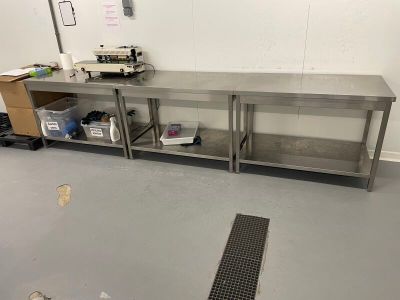 a kitchen with a metal counter and a metal sink