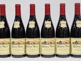 six bottles of red wine are lined up in a row
