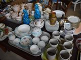 a table with a lot of dishes and cups on it