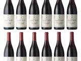 a group of bottles of red wine sitting on top of each other