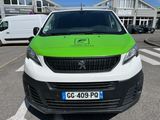 a green and white van parked in a parking lot