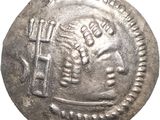 a silver coin with a man holding a hammer and a hammer