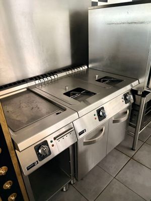 a kitchen with a stove, oven, and refrigerator in it