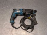 a cord connected to a drill on a metal surface