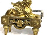 a gold statue of a winged lion on top of a table