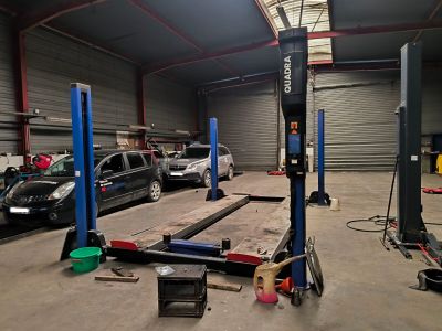 a car that is parked in a garage with a lift