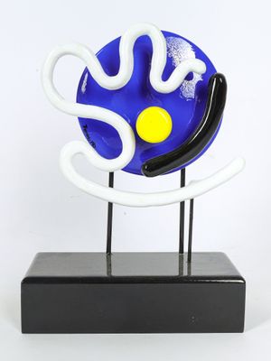 a close up of a blue and white sculpture on a black stand