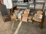 a pile of boxes and chairs in a garage